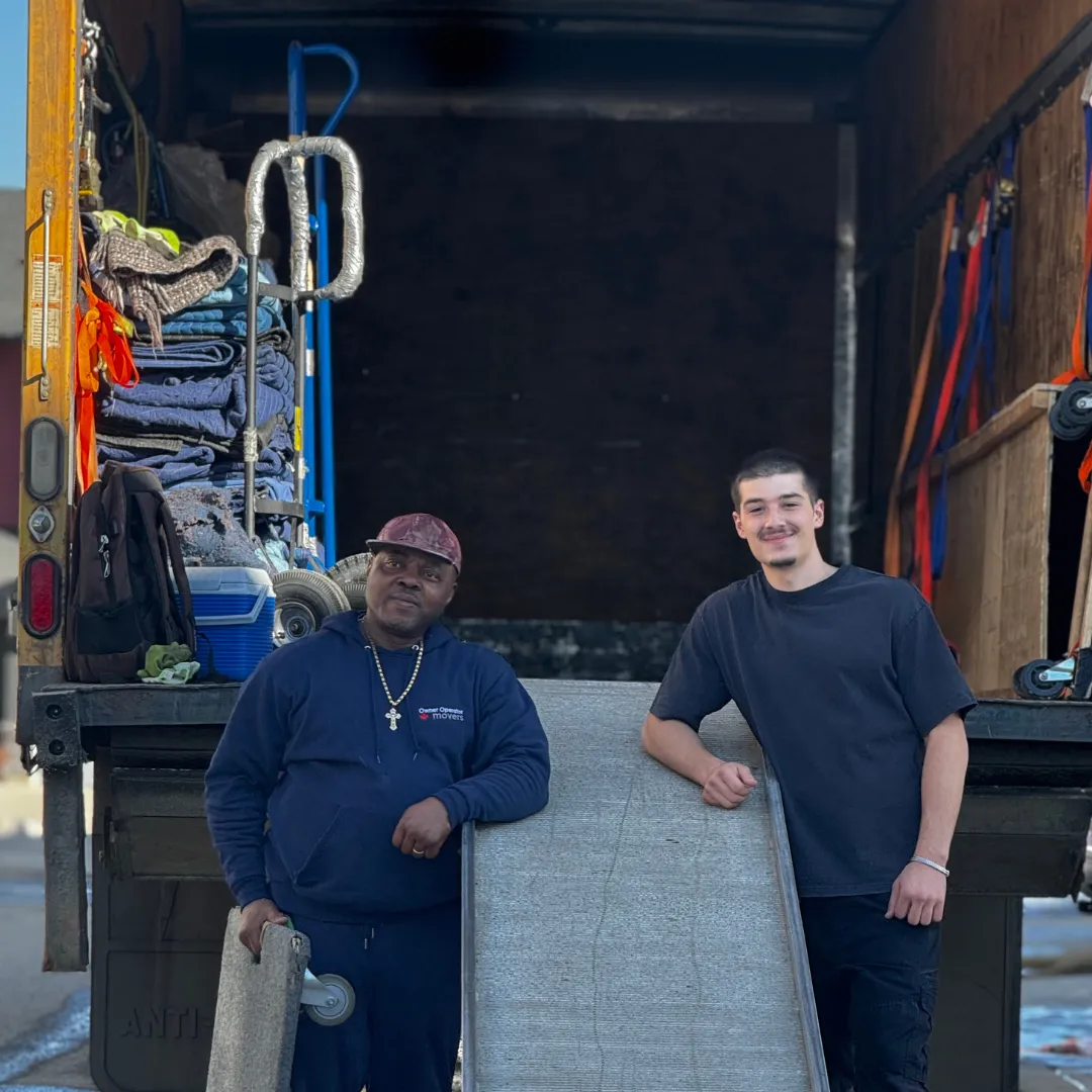 Janzen with the owner of Star Family Movers at a loaded moving truck
